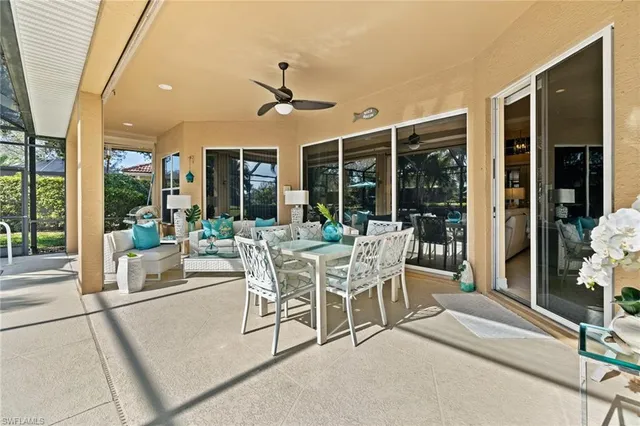 a dining room with furniture a table and a potted plant
