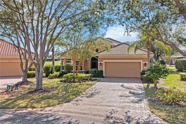 a view of a house with a tree and a yard