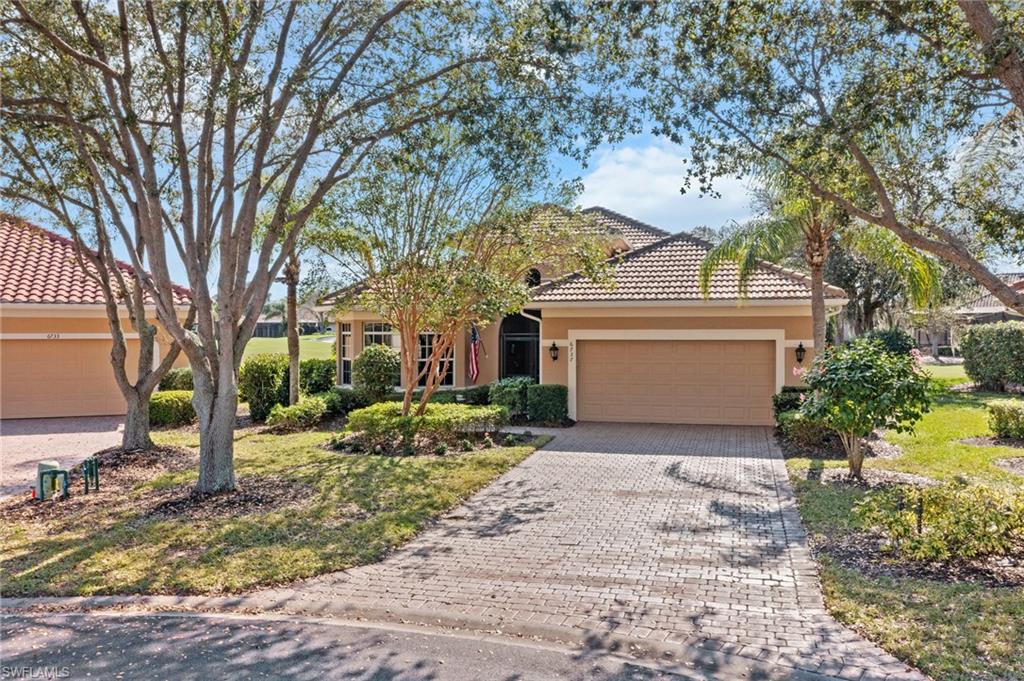 6737 Bent Grass Drive Naples, FL 34113 - Photo 2 of 31 a view of a house with a tree and a yard