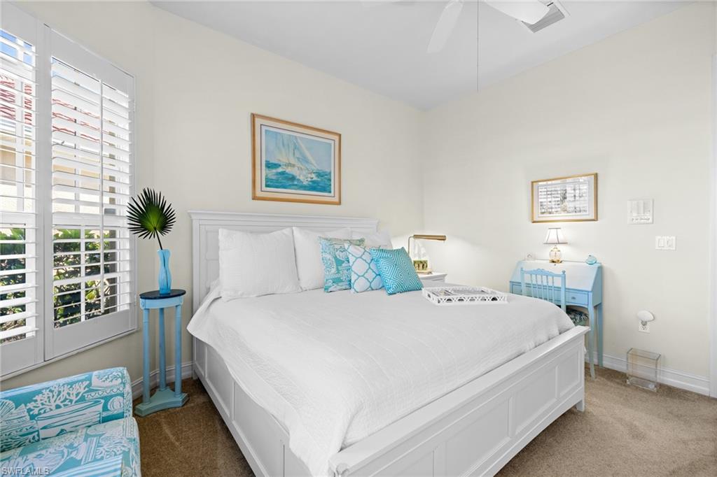 6737 Bent Grass Drive Naples, FL 34113 - Photo 21 of 31 a bedroom with a bed and a window