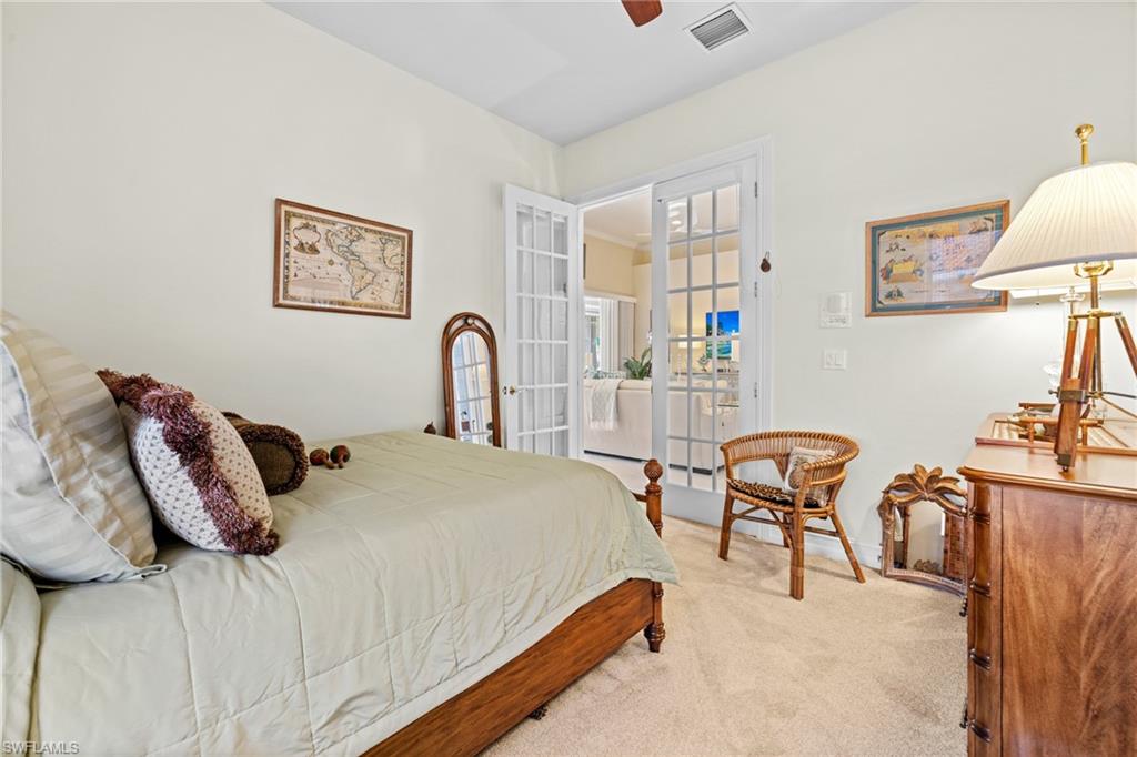6737 Bent Grass Drive Naples, FL 34113 - Photo 26 of 31 a bedroom with bed and a table