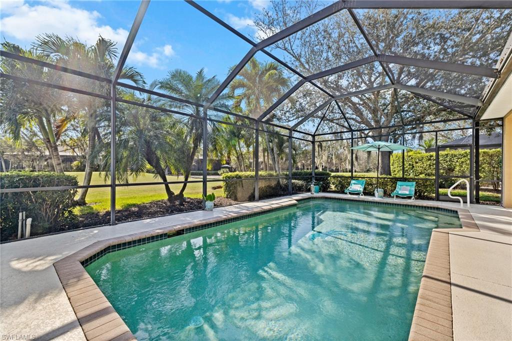 6737 Bent Grass Drive Naples, FL 34113 - Photo 30 of 31 a view of a swimming pool with a patio
