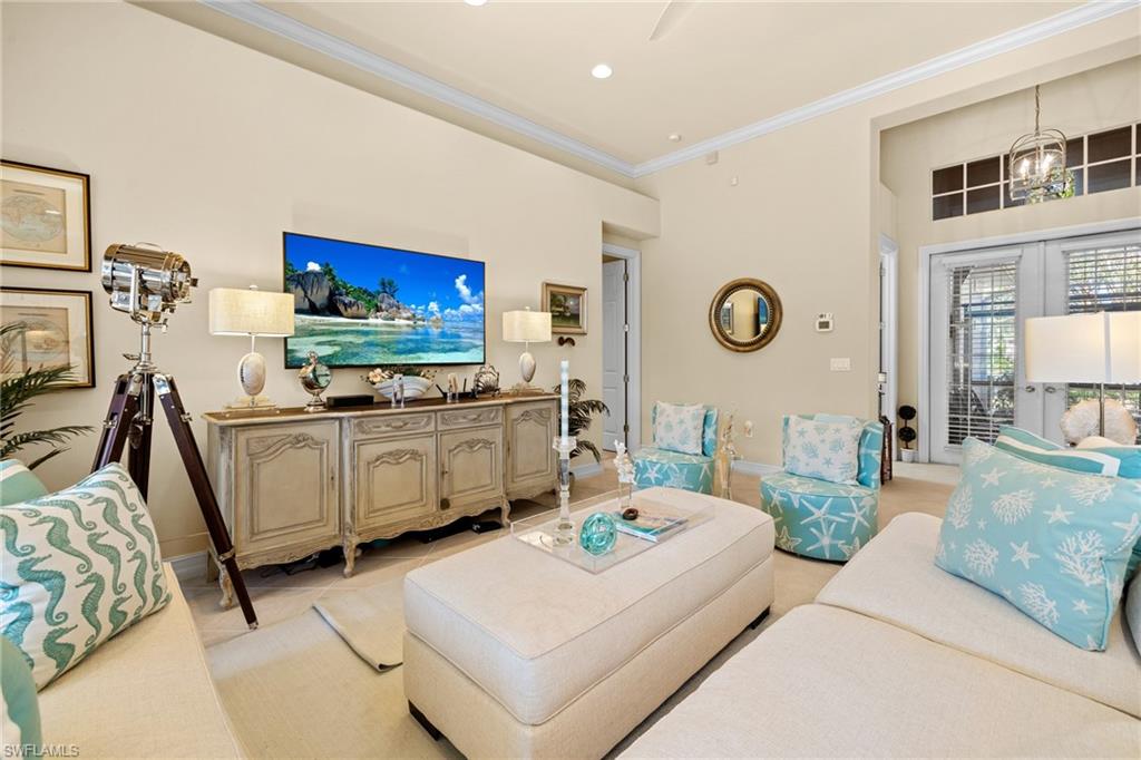 6737 Bent Grass Drive Naples, FL 34113 - Photo 5 of 31 a living room with furniture and a flat screen tv