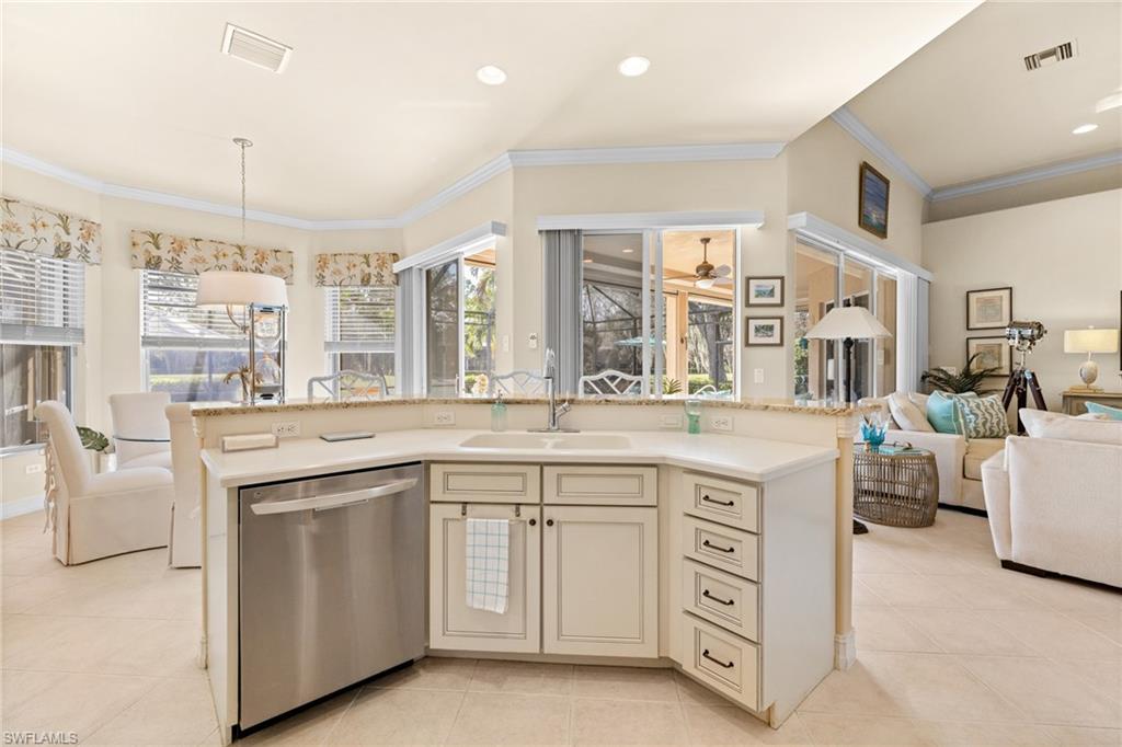 6737 Bent Grass Drive Naples, FL 34113 - Photo 9 of 31 a kitchen with cabinets and sink