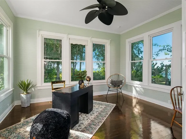 a living room with furniture and large windows
