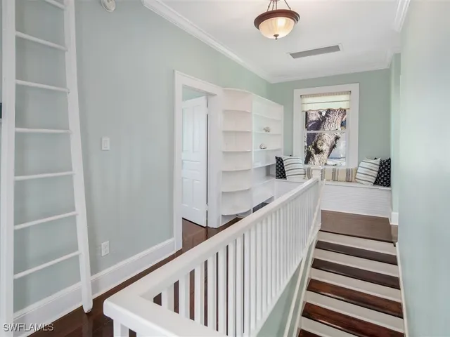 a view of entryway and hall with wooden floor