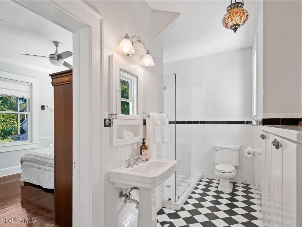 101 Fairview Avenue Fort Myers, FL 33905 - Photo 22 of 34 a bathroom with a sink a toilet a mirror and shower