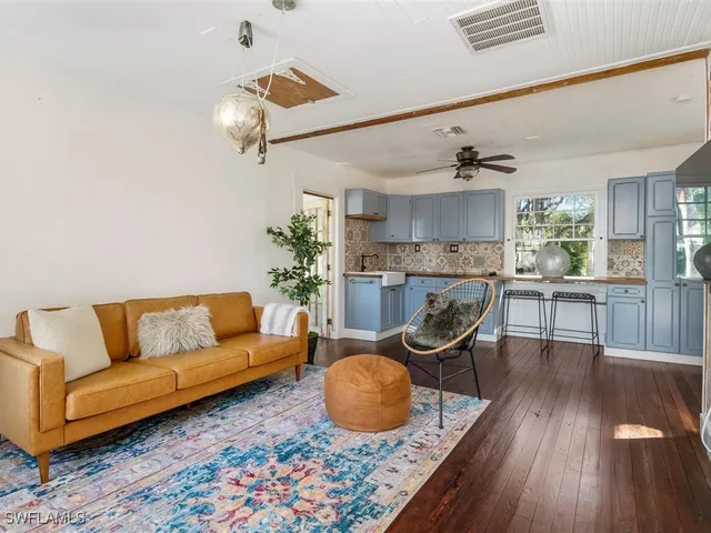 a living room with furniture and kitchen view