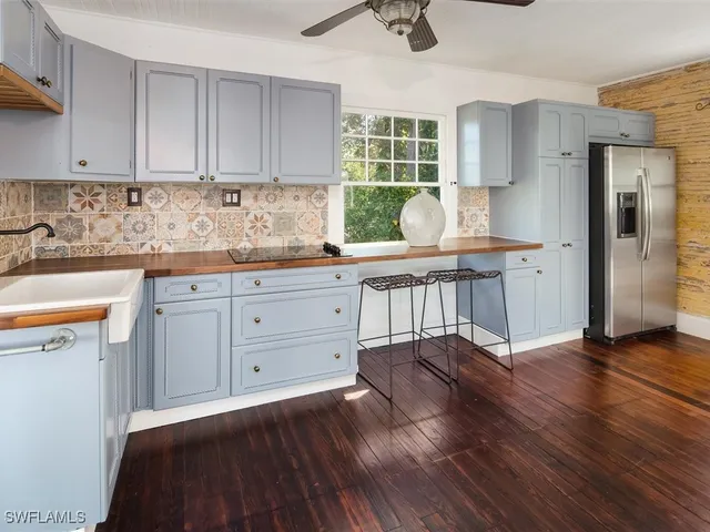 a kitchen with a white cabinets and window