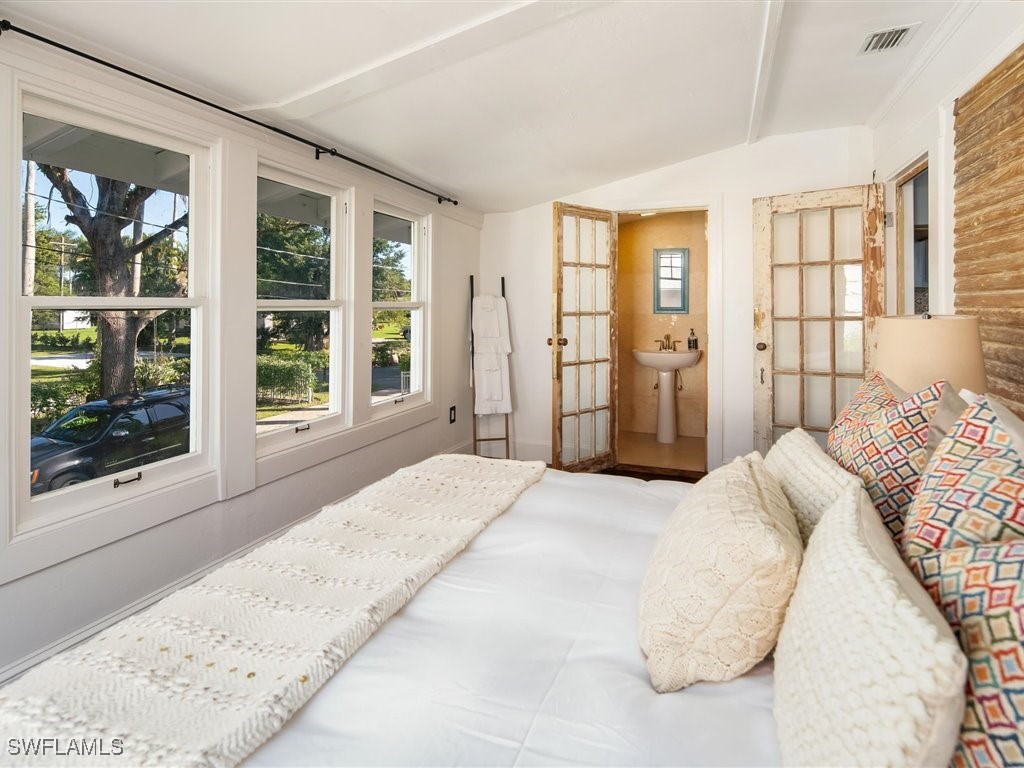 101 Fairview Avenue Fort Myers, FL 33905 - Photo 27 of 34 a bedroom with a large bed and a large window