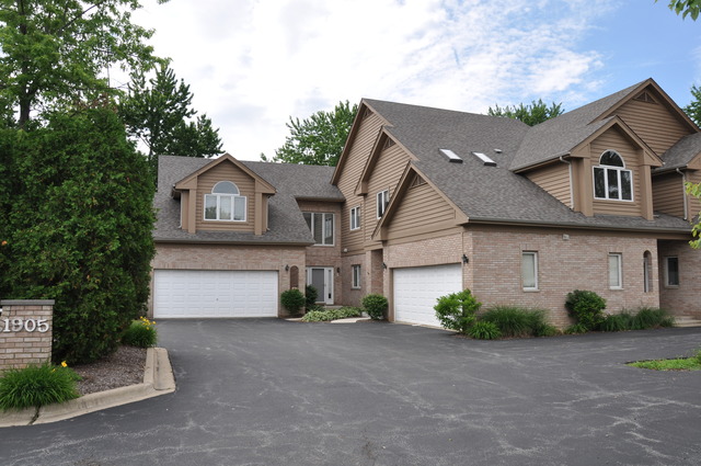 1905 Plainfield Road, Unit C Downers Grove, IL 60516 - Photo 18 of 20 a front view of a house with a yard and garage