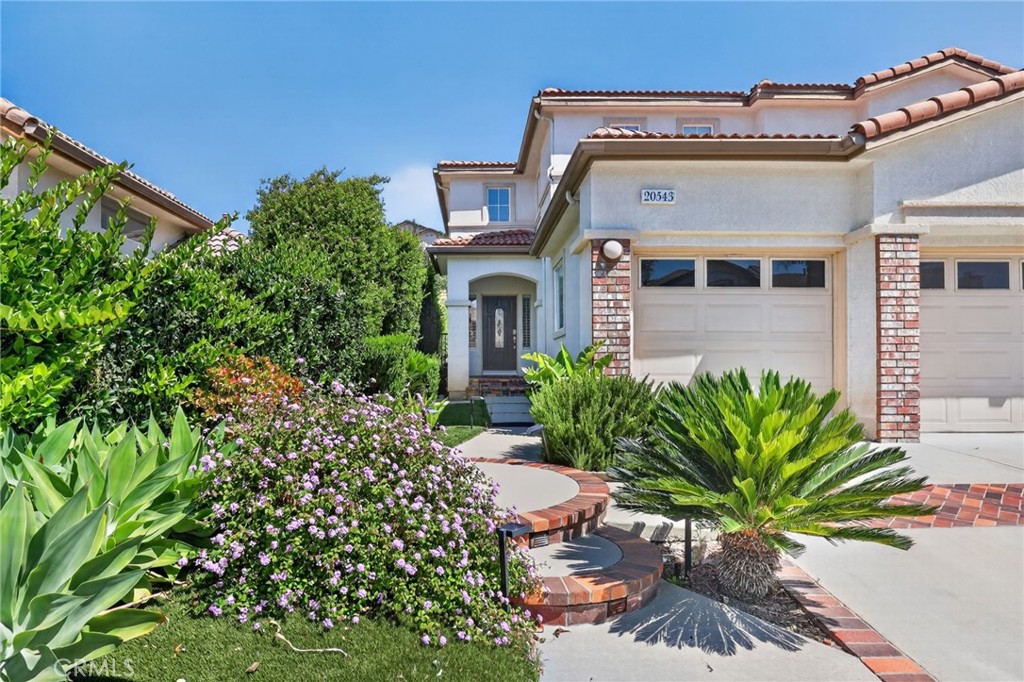 20543 Pesaro Porter Ranch Porter Ranch, CA 91326 - Photo 4 of 67 a front view of a house with a yard