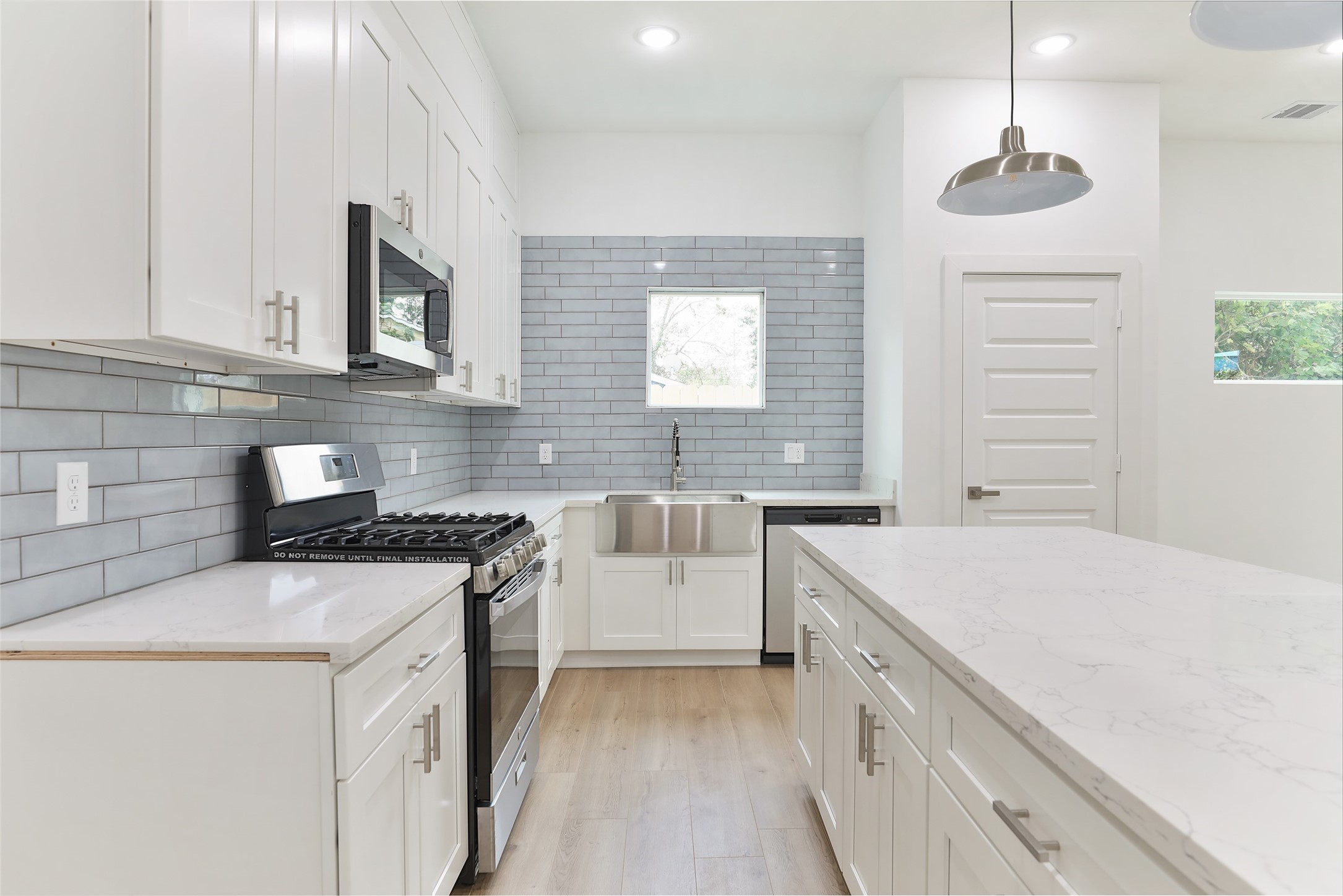 9349 Lavender Street Houston, TX 77016 - Photo 5 of 29 a kitchen with a stove sink and cabinets