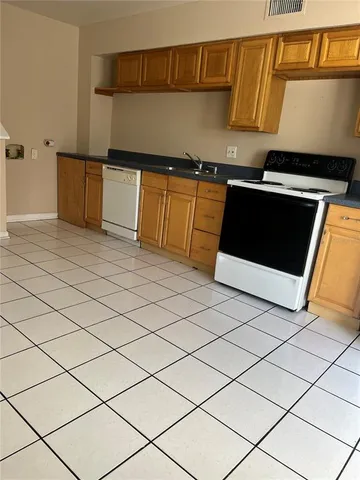 a kitchen with stainless steel appliances a stove a sink and a refrigerator