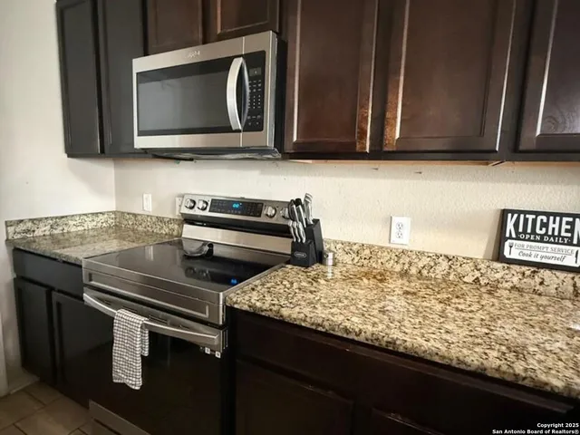 a kitchen with a stove and a microwave
