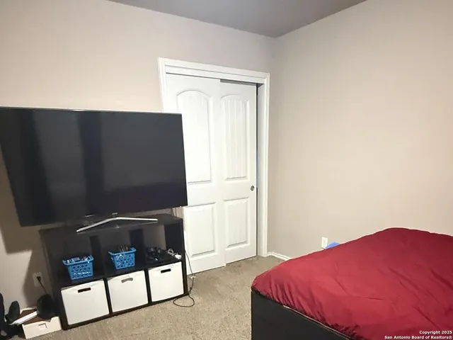 a bedroom with a bed and a mirror