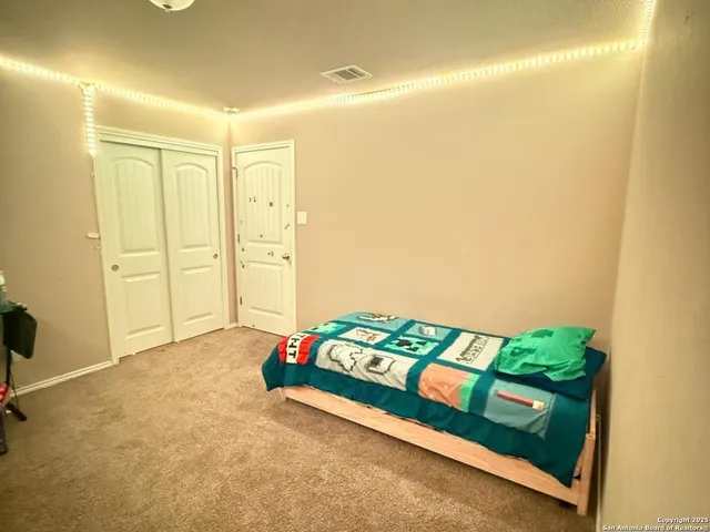 a bedroom with a bed and a dresser