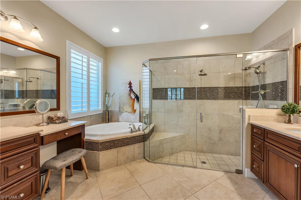 7810 Martino Circle Naples, FL 34112 - Photo 13 of 23 a bathroom with a double vanity sink toilet and shower