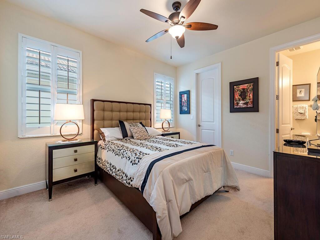 7810 Martino Circle Naples, FL 34112 - Photo 14 of 23 a bedroom with a large bed and a window