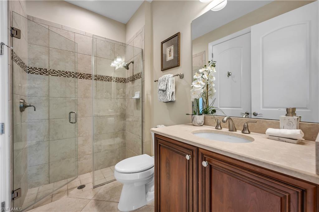 7810 Martino Circle Naples, FL 34112 - Photo 15 of 23 a bathroom with a sink a toilet and shower
