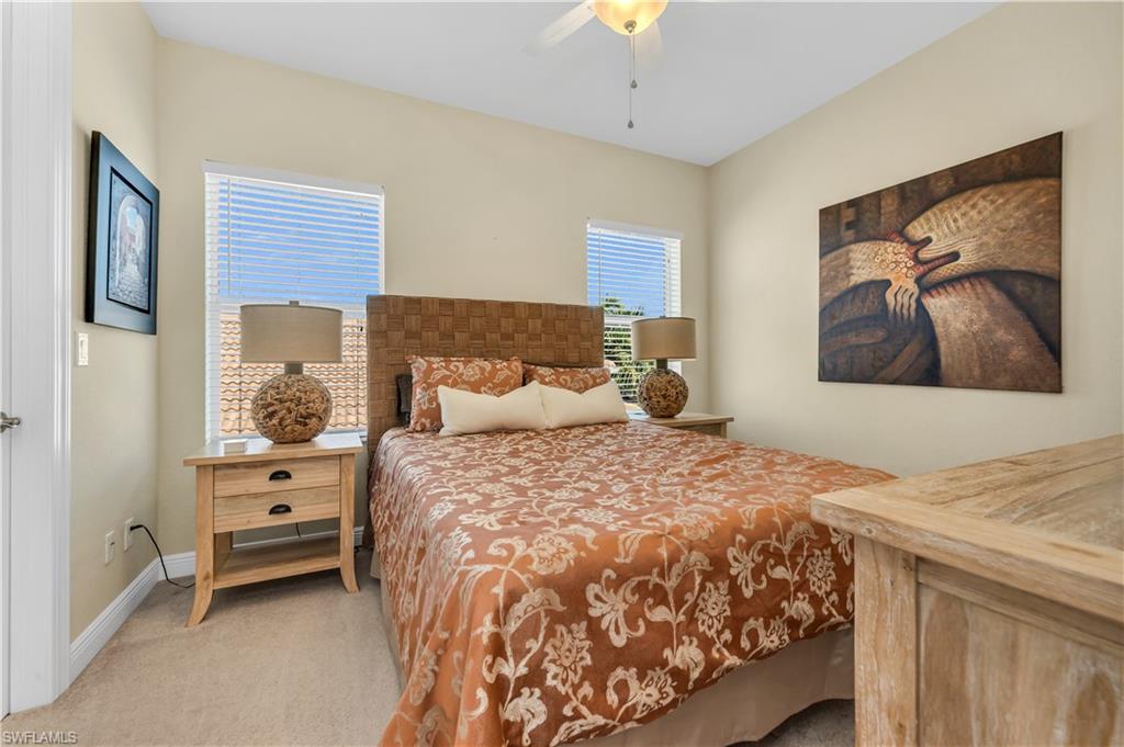 7810 Martino Circle Naples, FL 34112 - Photo 16 of 23 a bedroom with a bed and a painting on the wall