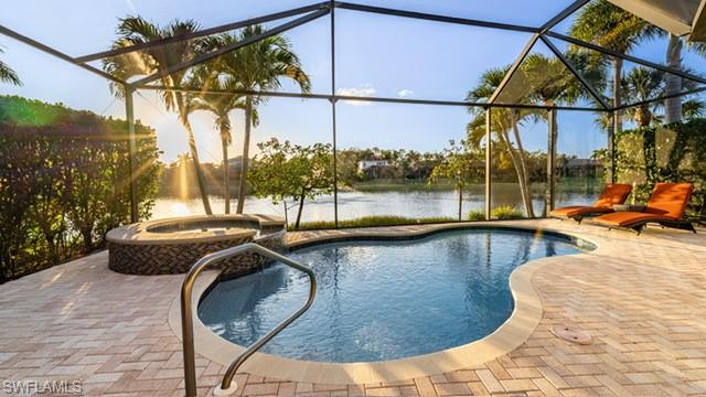 7810 Martino Circle Naples, FL 34112 - Photo 21 of 23 a view of a swimming pool with a lounge chairs