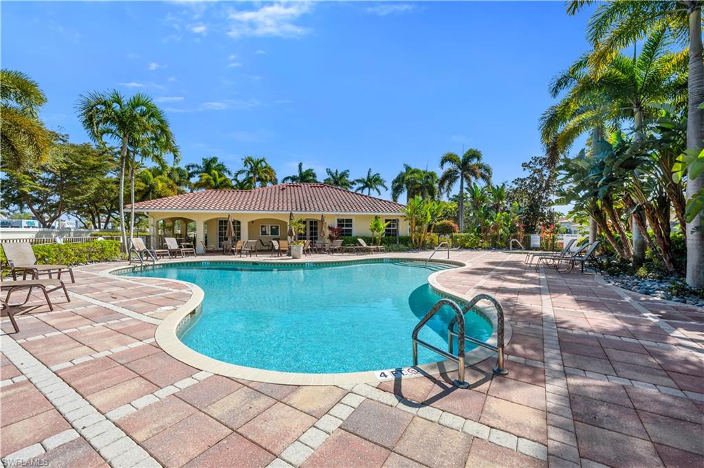 7810 Martino Circle Naples, FL 34112 - Photo 22 of 23 a view of a swimming pool with lounge chair