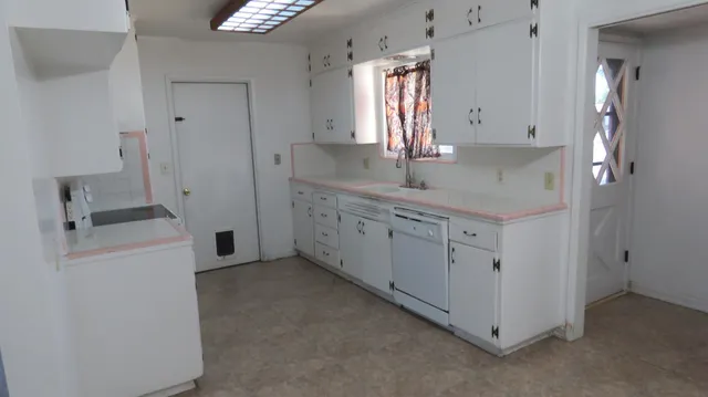 a kitchen with a sink and cabinets