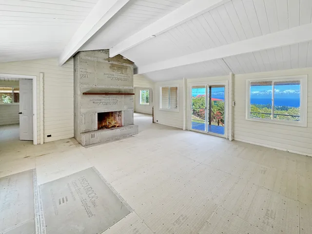 an empty room with furniture and a fireplace