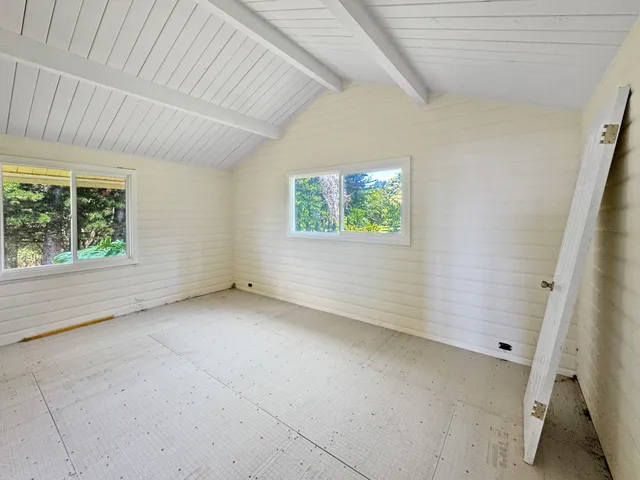 an empty room with a closet and mirrors