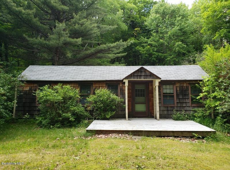 143 Sandisfield Road Monterey, MA 01245 - Photo 1 of 16 a front view of a house with a yard