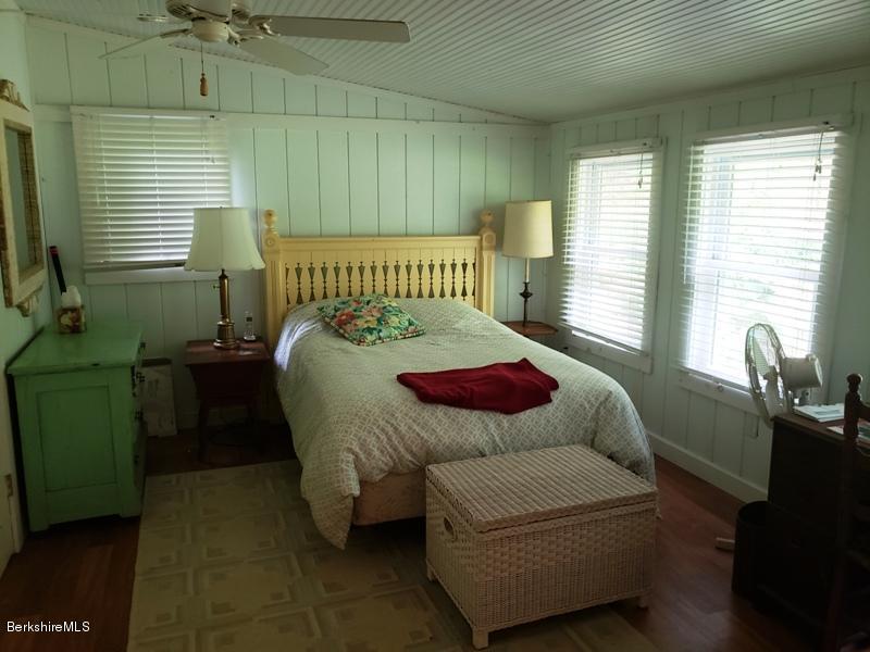 143 Sandisfield Road Monterey, MA 01245 - Photo 11 of 16 a bedroom with a bed next to a window