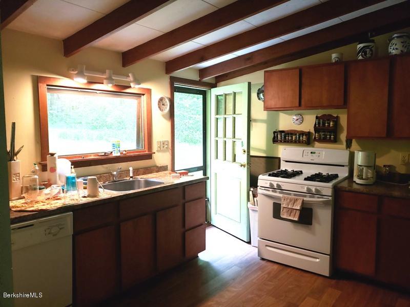 143 Sandisfield Road Monterey, MA 01245 - Photo 8 of 16 a kitchen with a stove a sink and a window