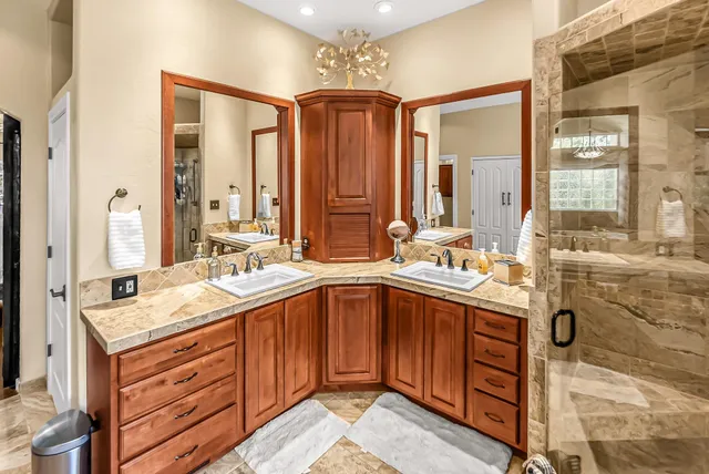 a bathroom with a sink double vanity shower and a mirror