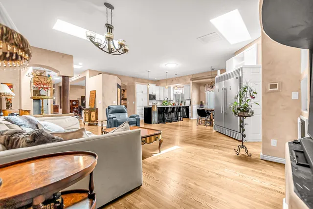 a living room with fireplace furniture and a large window
