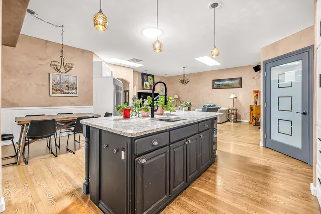 a kitchen with granite countertop a sink and a refrigerator