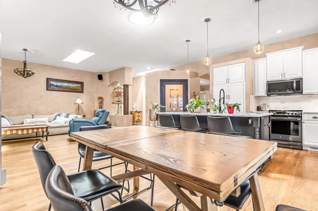 a large kitchen with a table and chairs