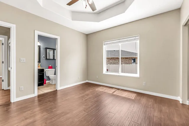 a view of a livingroom with wooden floor and a window