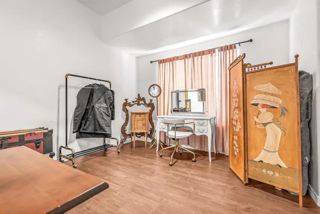 a bedroom with furniture and a window