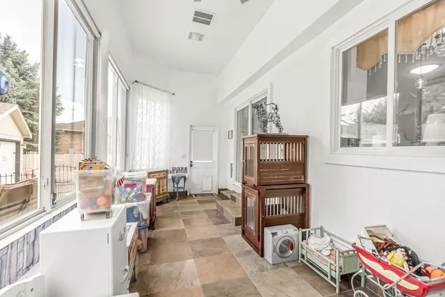 a bedroom with furniture and a large window