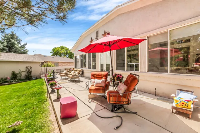 a view of swimming pool with red chairs in patio