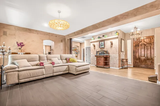a living room with furniture and a chandelier