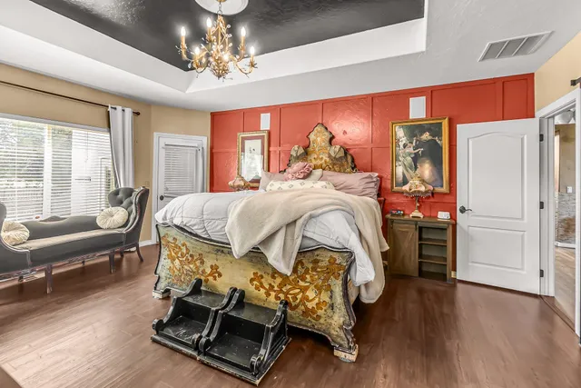 a bedroom with a bed and a chandelier