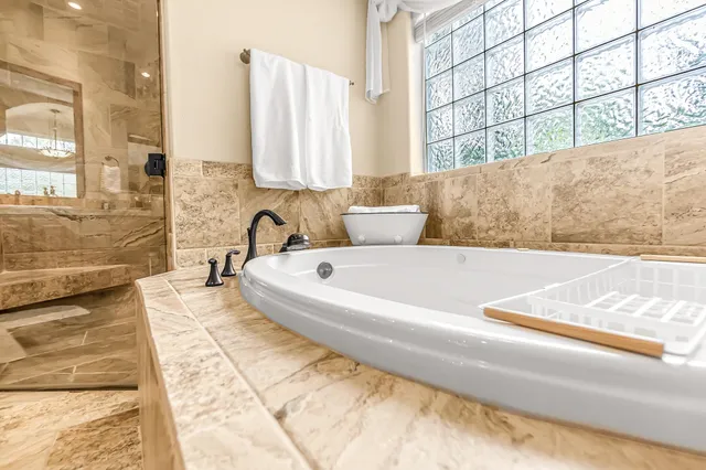 a view of a bathroom with bathtub and window