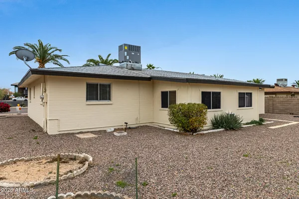 a view of a house with a backyard