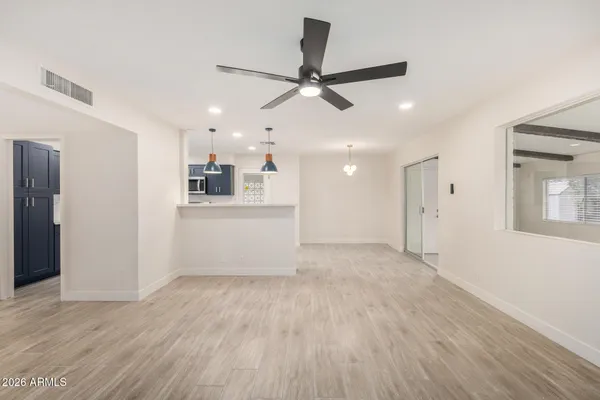 a view of a kitchen with a sink and wooden floor