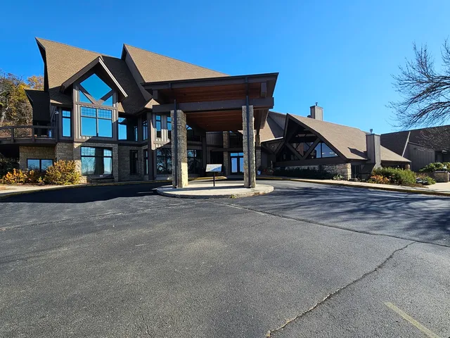 a view of swimming pool with an ocean and trees in the background