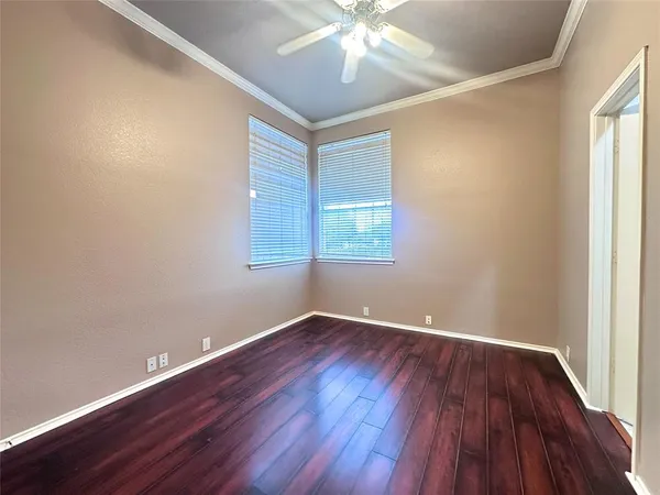 a view of an empty room with wooden floor