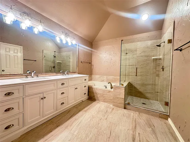 a bathroom with a double vanity sink toilet mirror and bathtub