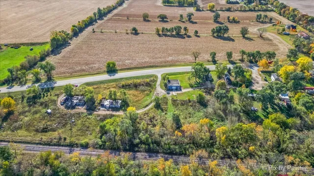 an aerial view of a house with a yard basket ball court